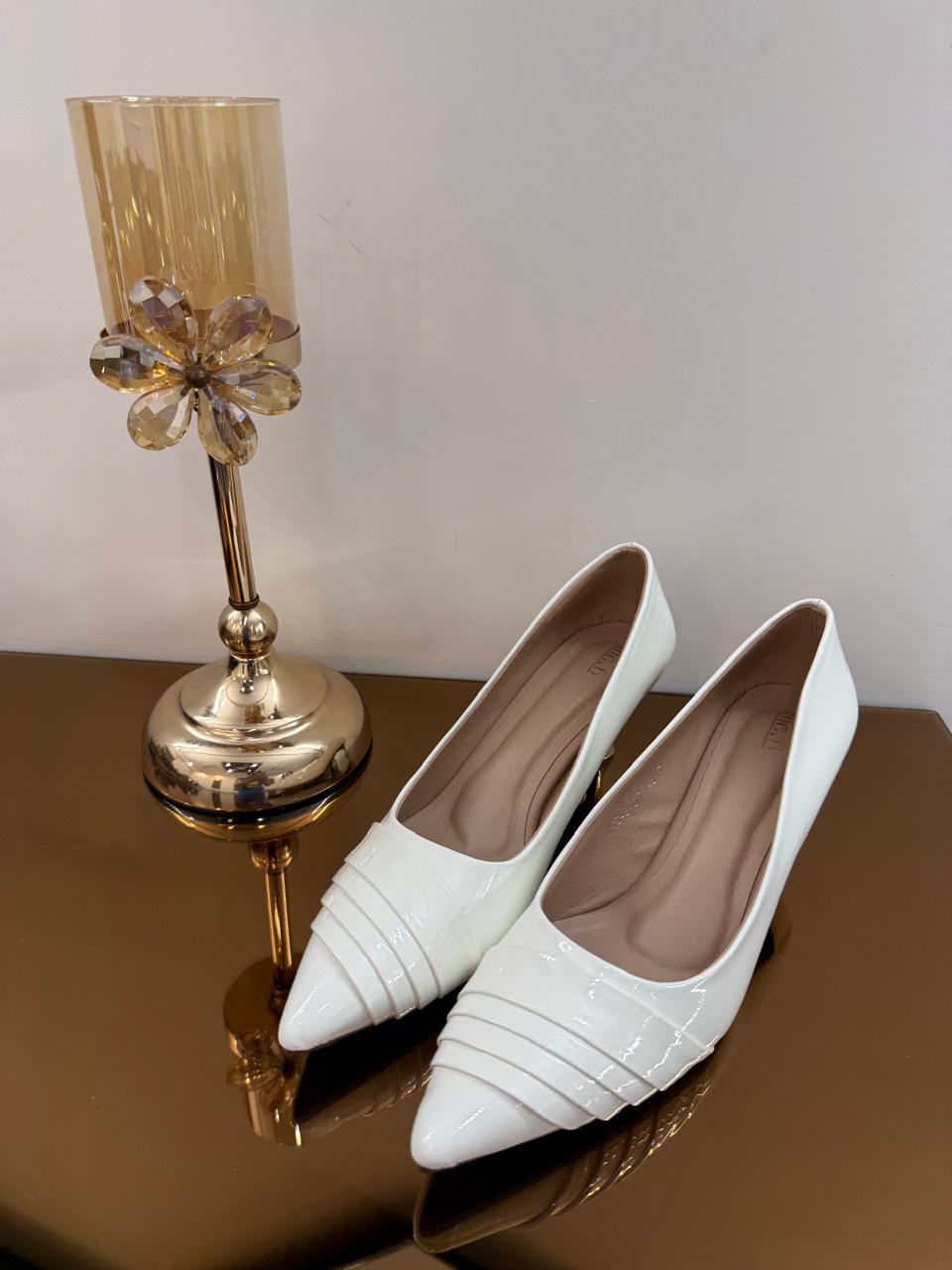 Elegant white pointed-toe heels with a glossy finish and comfortable mid heel. Perfect for office wear, parties, weddings, brunch dates, and everyday fashion styling.